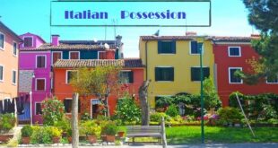 A block of Italian homes with a bench out front to discuss the grammar of Italian Possession